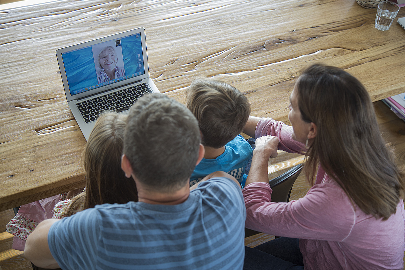 Una famiglia di quattro persone si incontra su Skype con la nonna.